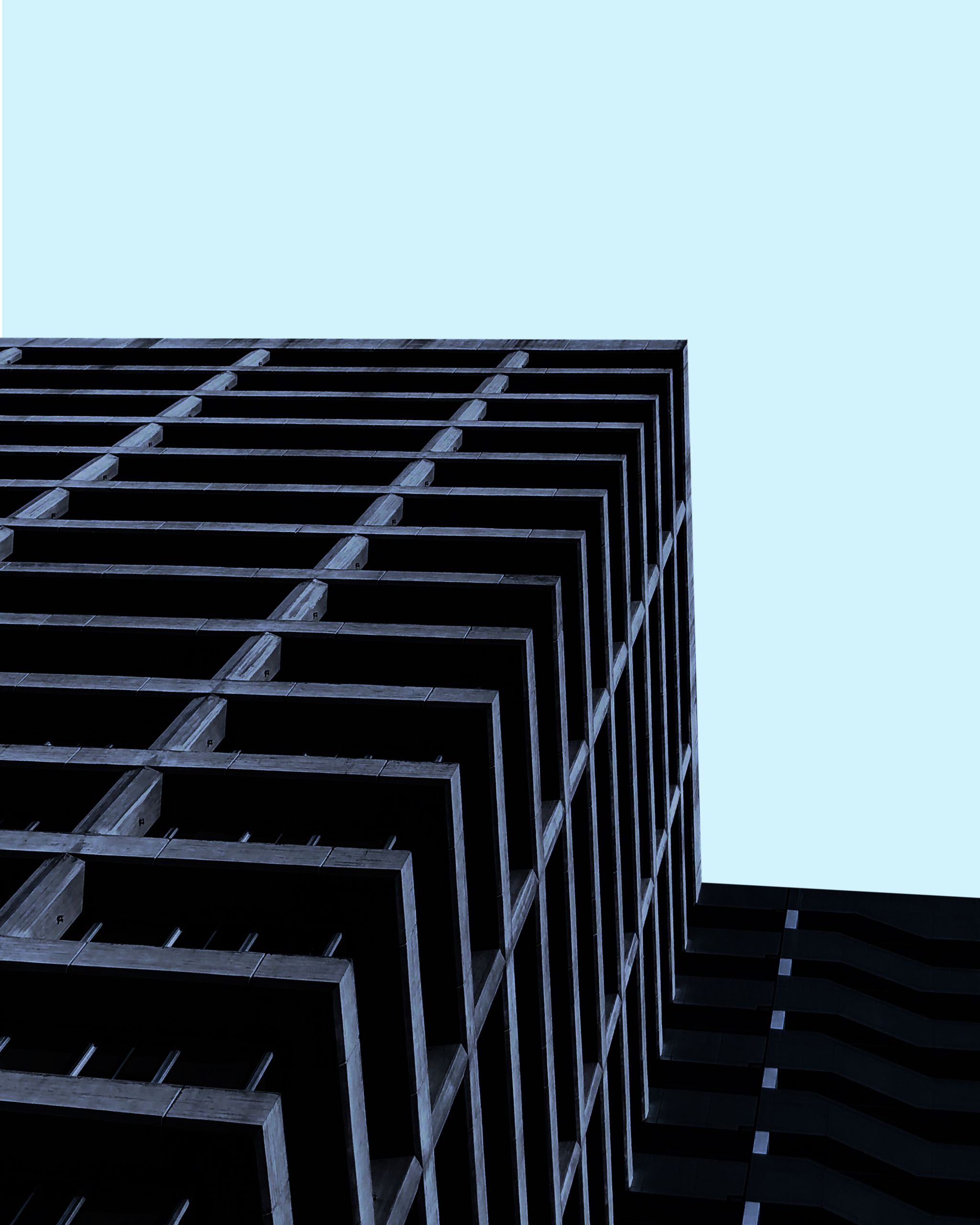 Low angle view of a modern minimalist building against a clear blue sky in Santiago.